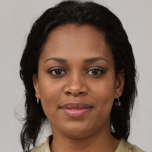 Joyful black adult female with medium  brown hair and brown eyes