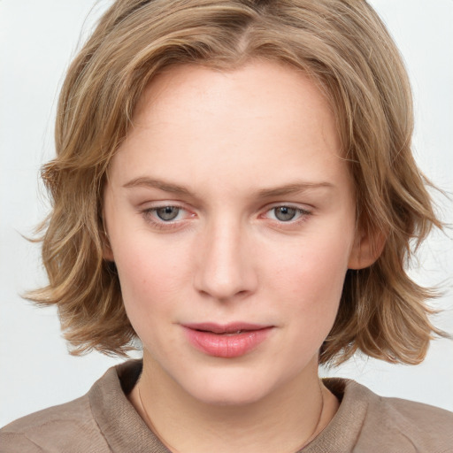 Joyful white young-adult female with medium  brown hair and blue eyes