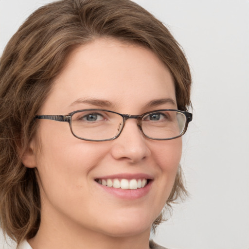 Joyful white young-adult female with medium  brown hair and green eyes