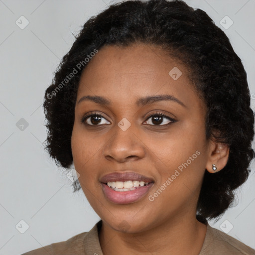 Joyful black young-adult female with long  black hair and brown eyes