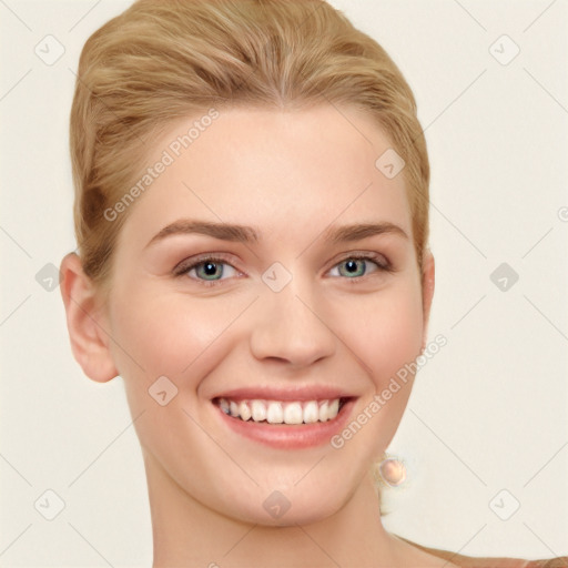 Joyful white young-adult female with short  brown hair and blue eyes