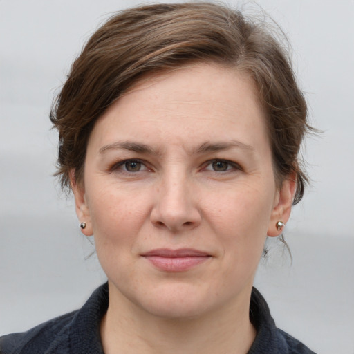 Joyful white young-adult female with medium  brown hair and grey eyes