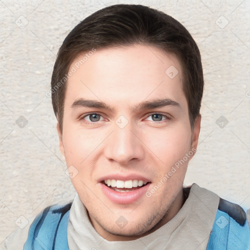 Joyful white young-adult male with short  brown hair and grey eyes