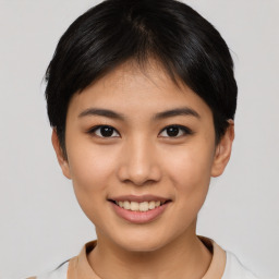 Joyful asian young-adult female with short  brown hair and brown eyes