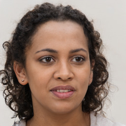 Joyful black young-adult female with medium  brown hair and brown eyes