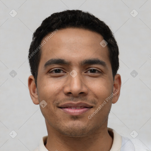 Joyful latino young-adult male with short  black hair and brown eyes