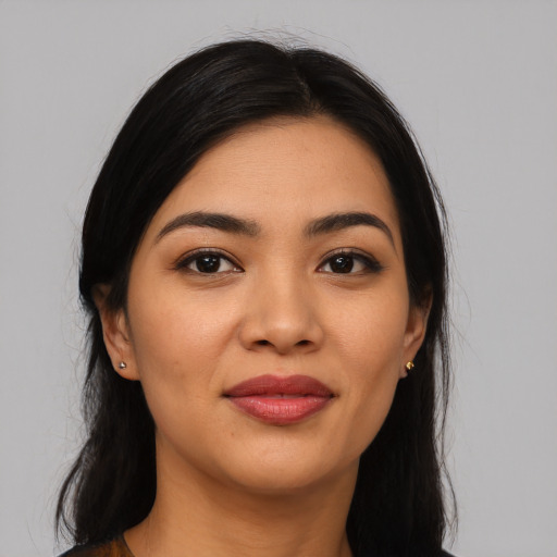 Joyful latino young-adult female with long  black hair and brown eyes