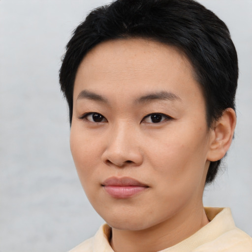 Joyful asian young-adult female with short  black hair and brown eyes