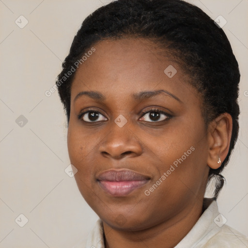 Joyful black young-adult female with short  brown hair and brown eyes