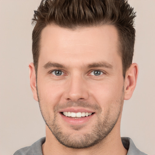 Joyful white young-adult male with short  brown hair and brown eyes