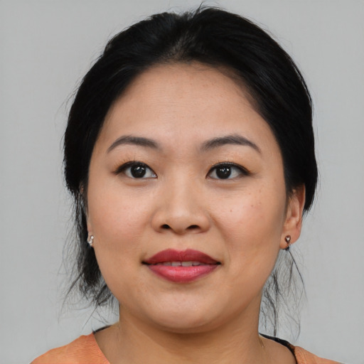 Joyful asian young-adult female with medium  black hair and brown eyes