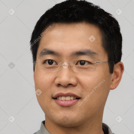 Joyful asian young-adult male with short  black hair and brown eyes