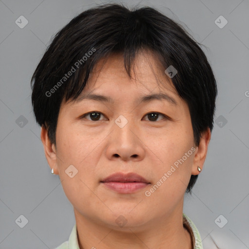 Joyful asian adult female with short  brown hair and brown eyes