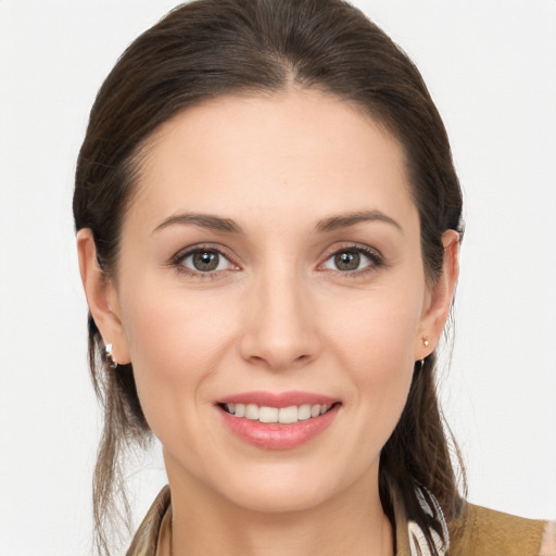 Joyful white young-adult female with long  brown hair and brown eyes