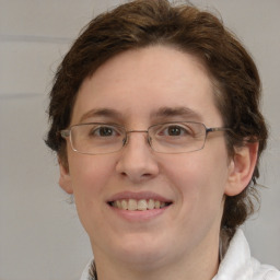 Joyful white young-adult female with medium  brown hair and green eyes