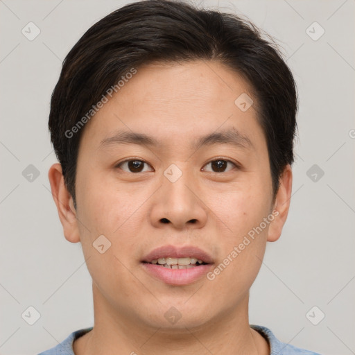 Joyful asian young-adult male with short  brown hair and brown eyes