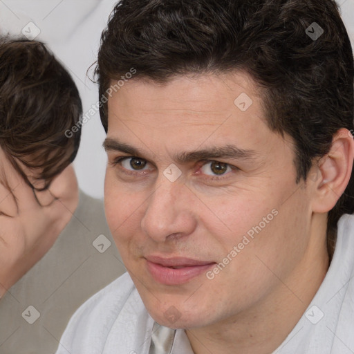 Joyful white adult male with short  brown hair and brown eyes