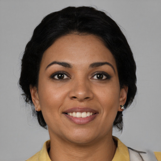 Joyful latino young-adult female with medium  black hair and brown eyes