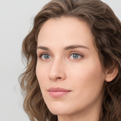 Neutral white young-adult female with long  brown hair and green eyes