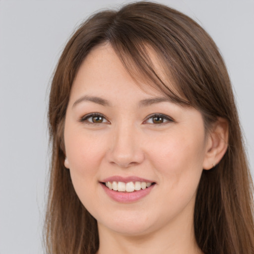 Joyful white young-adult female with long  brown hair and brown eyes