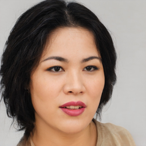 Joyful asian young-adult female with medium  black hair and brown eyes