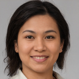 Joyful asian young-adult female with medium  brown hair and brown eyes