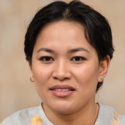 Joyful asian young-adult female with medium  brown hair and brown eyes