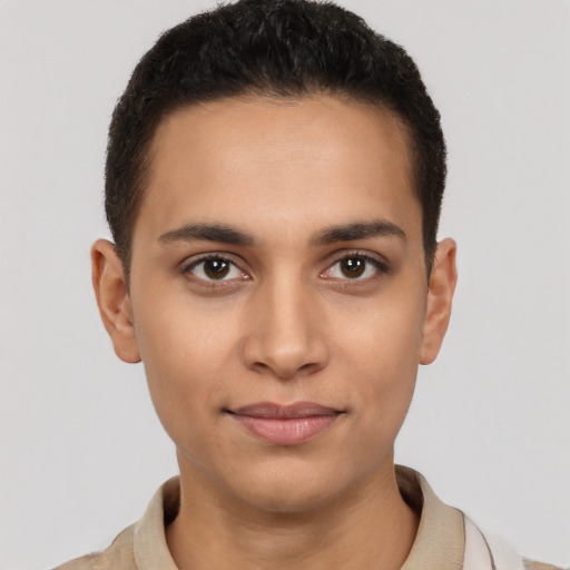 Joyful latino young-adult male with short  brown hair and brown eyes