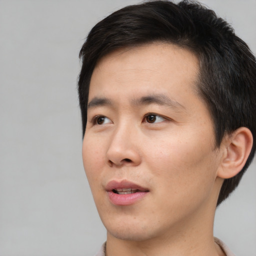 Neutral asian young-adult male with short  brown hair and brown eyes