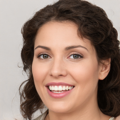 Joyful white young-adult female with medium  brown hair and brown eyes