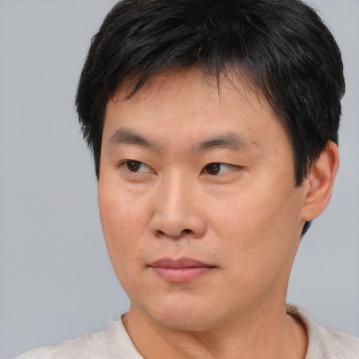 Neutral asian young-adult male with short  brown hair and brown eyes