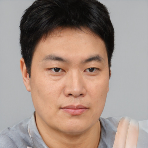 Neutral asian young-adult male with short  brown hair and brown eyes