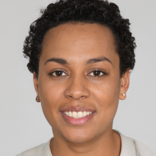 Joyful latino young-adult female with short  black hair and brown eyes