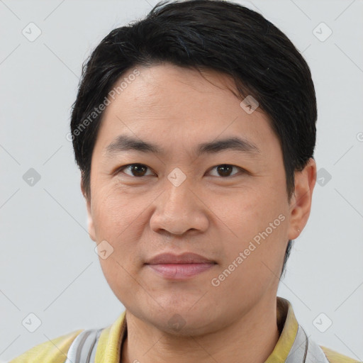 Joyful white young-adult male with short  black hair and brown eyes