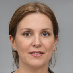 Joyful white adult female with medium  brown hair and grey eyes