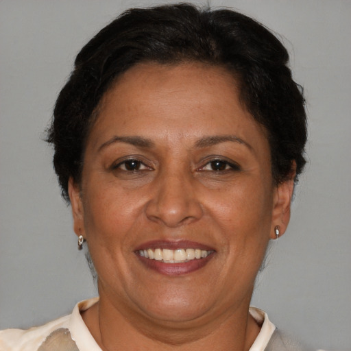 Joyful latino adult female with short  brown hair and brown eyes