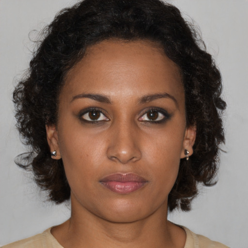Neutral black young-adult female with medium  brown hair and brown eyes