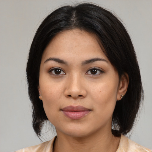 Joyful latino young-adult female with medium  black hair and brown eyes