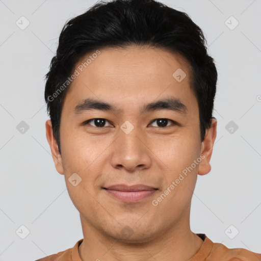 Joyful asian young-adult male with short  black hair and brown eyes