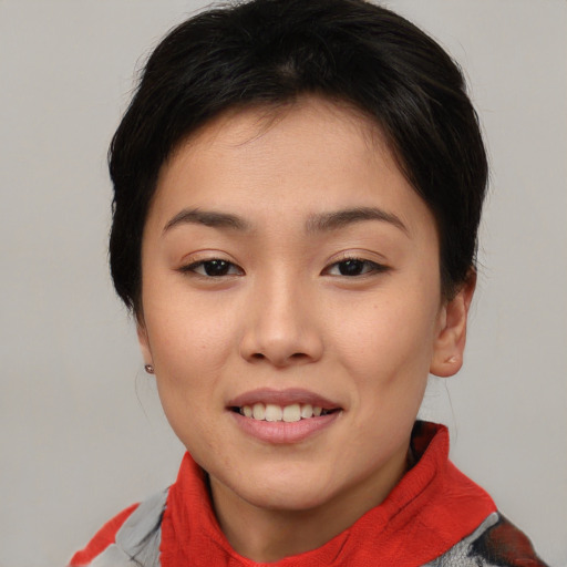 Joyful asian young-adult female with short  brown hair and brown eyes