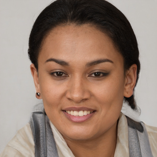 Joyful latino young-adult female with medium  brown hair and brown eyes