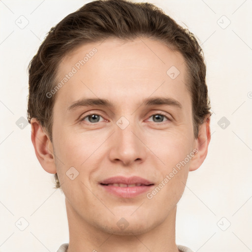 Joyful white young-adult male with short  brown hair and grey eyes