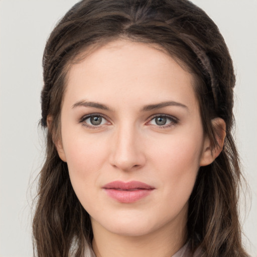 Joyful white young-adult female with long  brown hair and grey eyes