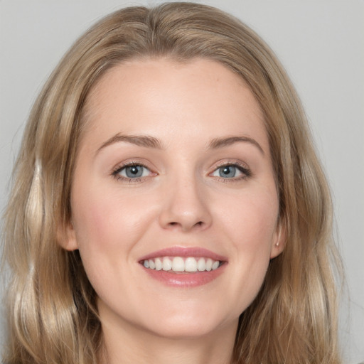 Joyful white young-adult female with long  brown hair and grey eyes