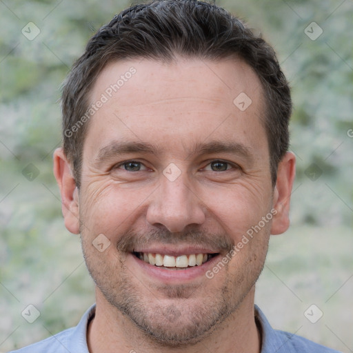 Joyful white adult male with short  brown hair and brown eyes