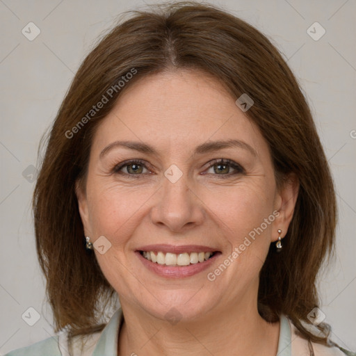 Joyful white adult female with medium  brown hair and grey eyes