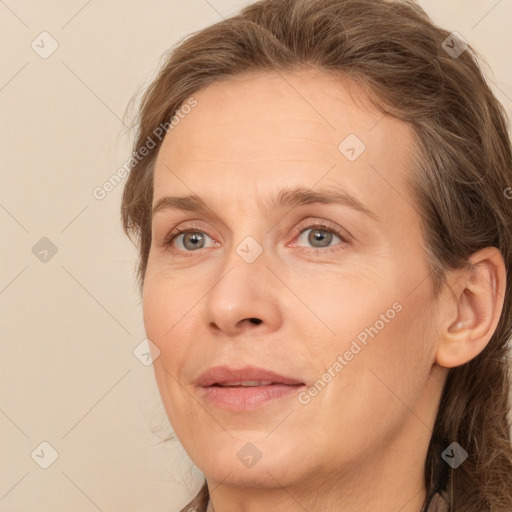 Joyful white adult female with long  brown hair and brown eyes