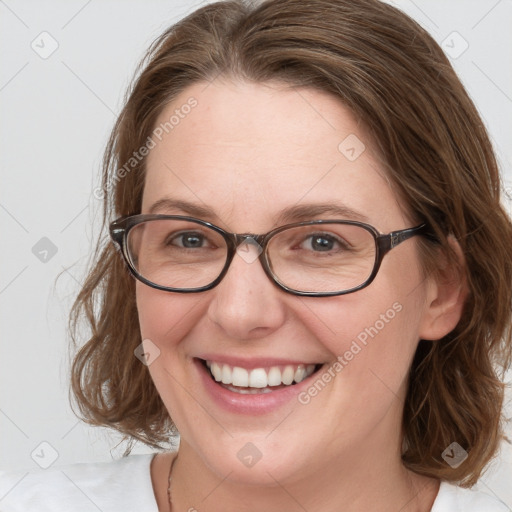 Joyful white young-adult female with medium  brown hair and blue eyes