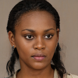 Neutral black young-adult female with medium  brown hair and brown eyes