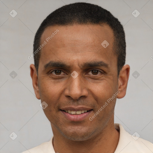 Joyful latino adult male with short  black hair and brown eyes